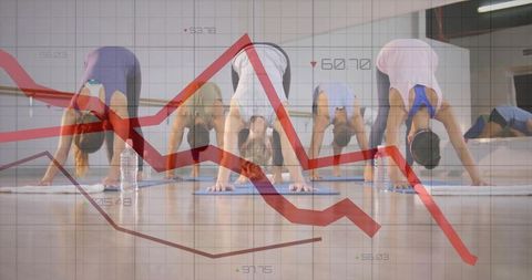 Group practicing downward dog in fitness studio with red declining market chart overlay
