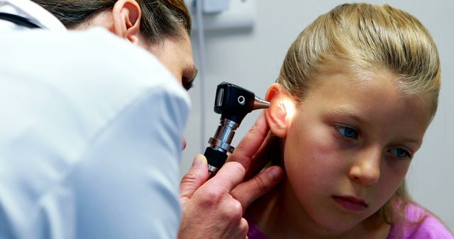 Doctor Examining Young Girl's Ear with Otoscope - Download Free Stock Images Pikwizard.com