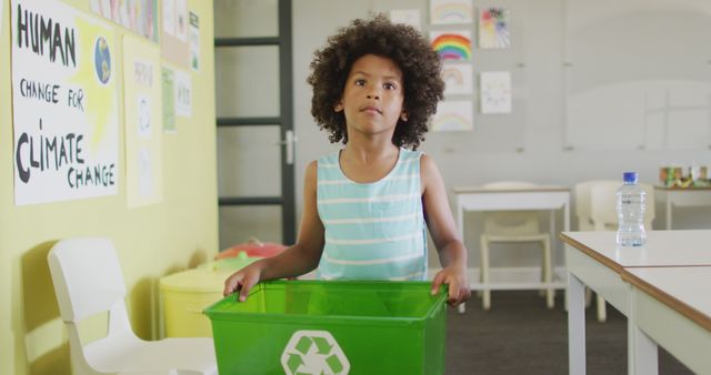 Image of happy african american boy holding box with recycling symbol in classroom - Download Free Stock Photos Pikwizard.com