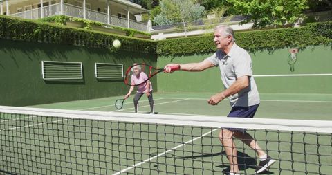 Senior Couple Playing Tennis on Sunny Day - Download Free Stock Images Pikwizard.com