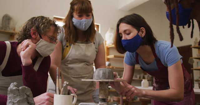 Group of Adults Enjoying Pottery Class Wearing Protective Masks - Download Free Stock Images Pikwizard.com