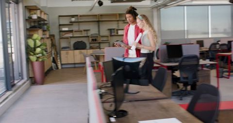 Colleagues Celebrating Success with Technology in Modern Office