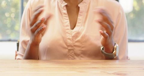 Businesswoman Gesturing Expressively During Workplace Discussion