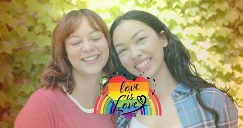 Smiling same-sex couple leaning heads with rainbow heart love is love graphic