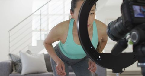 Asian woman prepares fitness vlog with camera equipment