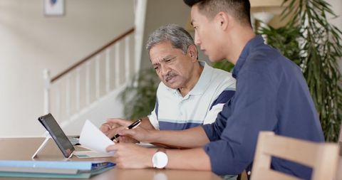 Financial Advisor Assisting Senior Client at Home