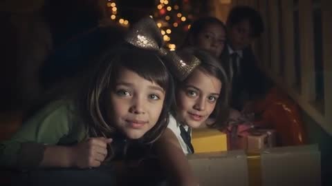 Girls Exploring Christmas Presents Near Festive Tree