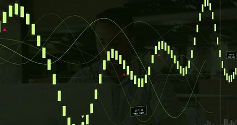 Trader studying candlestick charts with green data overlays in dim modern office