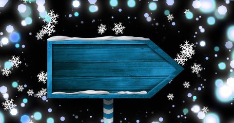 Blue Wooden Christmas Sign with Snowflakes and Bokeh Lights