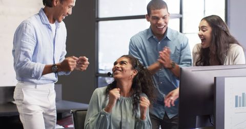 Diverse Business Team Celebrating Success at Office Workspace