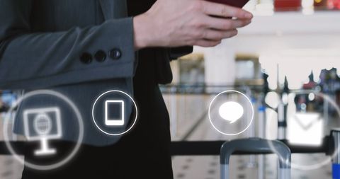 Businesswoman Engaging with Digital Icons at Airport
