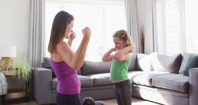 Mother and Daughter Exercising Together in Living Room - Download Free Stock Images Pikwizard.com