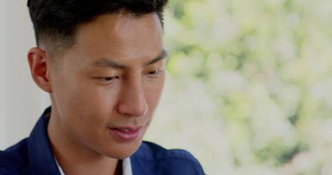 Asian Man Concentrating on Smartphone Call