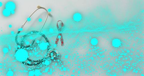 Stethoscope coiling around red awareness ribbon with cyan paint splatter overlay