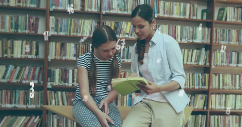 Teacher and student collaboratively reading in library environment