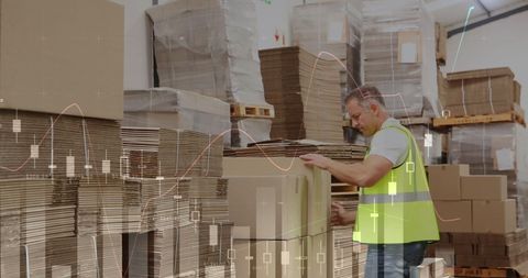 warehouse specialist organizing cardboard with financial overlay - Download Free Stock Images Pikwizard.com