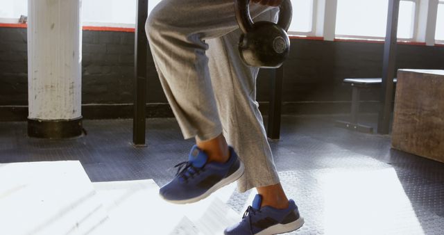 Man holding kettlebell during workout at gym - Download Free Stock Images Pikwizard.com