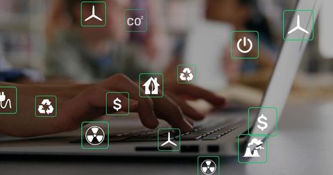 Hands Typing on Laptop with Floating Green Energy Icons Representing Sustainable Tech