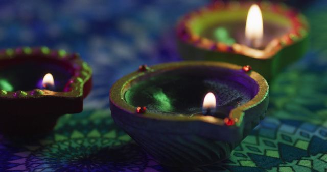 Traditional Diwali oil lamps are lit, creating a warm, festive atmosphere. Perfect for illustrating articles on Diwali celebrations, Indian festivals, and cultural customs. Use in social media posts, blogs, or promotional material for festivals. Highlight of Indian traditions and lighting decor.