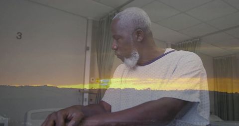 Surreal double exposure of older man in hospital gown with sunset horizon band