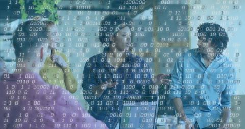 Team Brainstorming in Modern Office with Binary Code Overlay