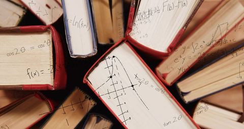 Radial stack hardcover books showing mathematical equations on visible page edges