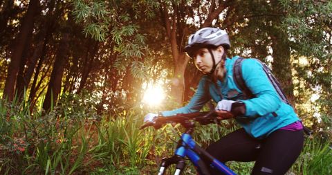 Female Biker Enjoying Mountain Trail in Forest at Sunset - Download Free Stock Images Pikwizard.com