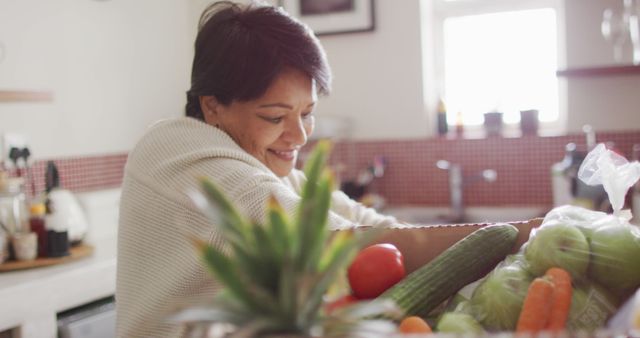 Smiling Woman Organizing Fresh Groceries in Kitchen - Download Free Stock Images Pikwizard.com