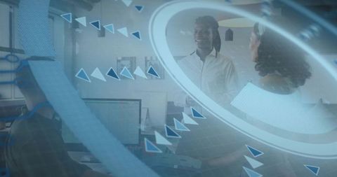 Male team leader guiding coworker in open-plan office with holographic interface