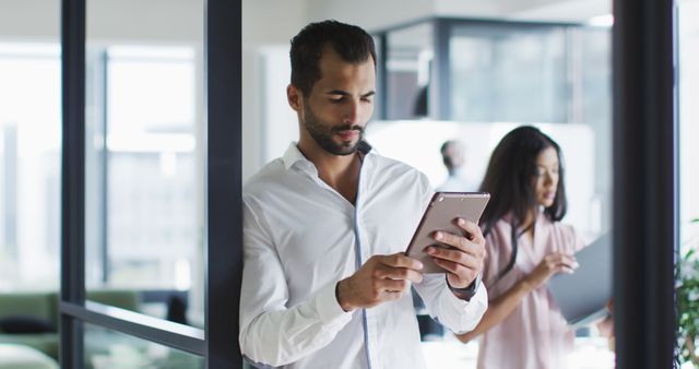 Professional Man Using Tablet in Modern Office - Download Free Stock Images Pikwizard.com