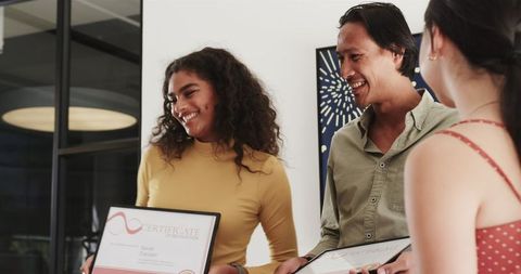 Happy colleagues celebrating achievements in modern office