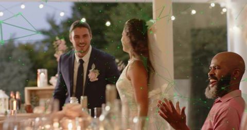 Romantic dusk wedding reception couple smiling bride and groom greeting applauding guests