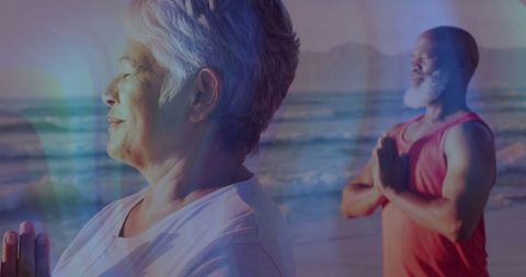 Senior Couple Practicing Mindfulness Meditation at Beach