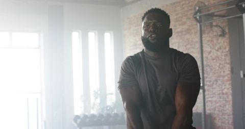 Focused Athlete Training with Battle Rope in Industrial Gym