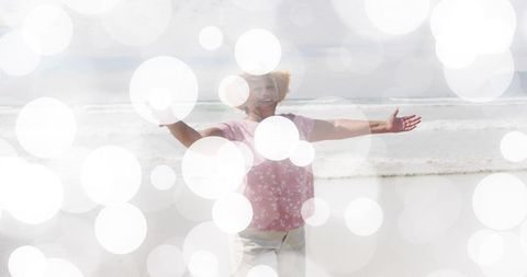 Senior Woman Embracing Beach Happiness with Bokeh Effect