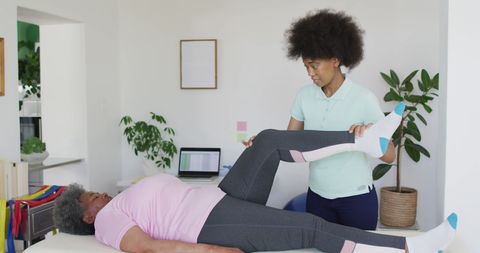 Senior Physiotherapy Session with African American Therapist at Home
