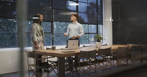 Diverse Professionals Celebrating Success in Modern Office at Night