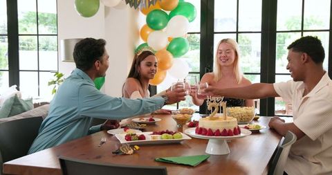 Friends Toast at Bright Indoor Birthday Celebration