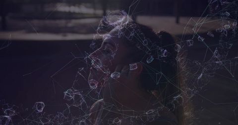 Backlit woman tilting head back gazing upward with wireframe network projection