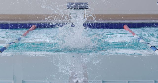 Splash between lanes and diving board at indoor pool, copy space. Competition, training, fitness, exercise, healthy lifestyle, sport, swimming and swimming pool,