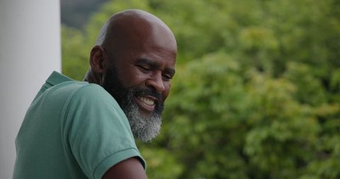 Bearded Man Relaxing and Smiling Outdoors