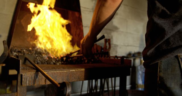 Blacksmith Working Metal in Forge with Bright Flames - Download Free Stock Images Pikwizard.com