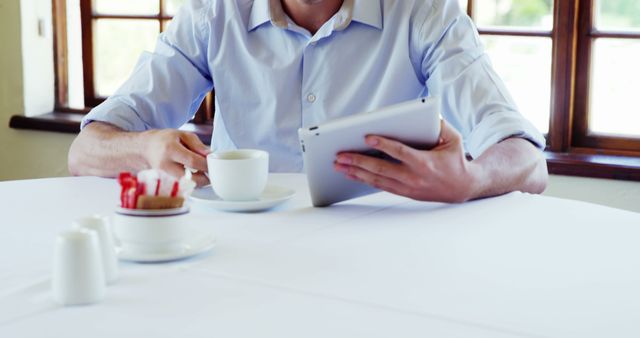 Person Reading Tablet and Drinking Coffee in Café - Download Free Stock Images Pikwizard.com