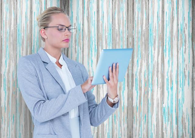 Businesswoman Working on Tablet Against Wooden Background - Download Free Stock Photos Pikwizard.com