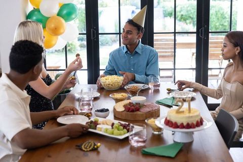 Friends Celebrating 21st Birthday with Cake and Popcorn Indoors