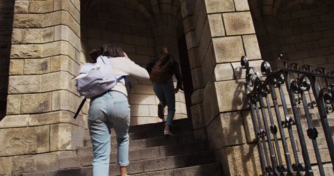 Students climbing stone steps towards historical venue
