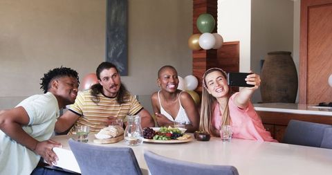 Friends Enjoying Lunch Sharing Laughter and Taking Selfie