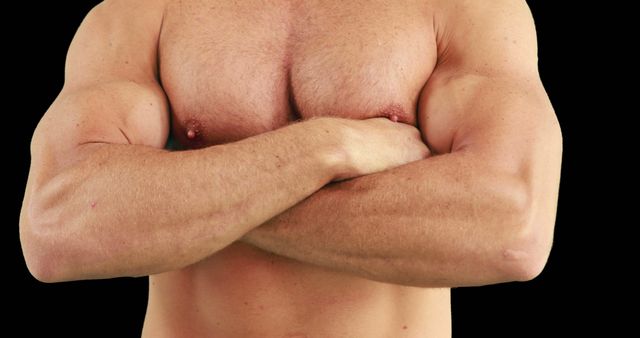 A Caucasian man's muscular upper body is shown as he crosses his arms, with copy space - Download Free Stock Photos Pikwizard.com