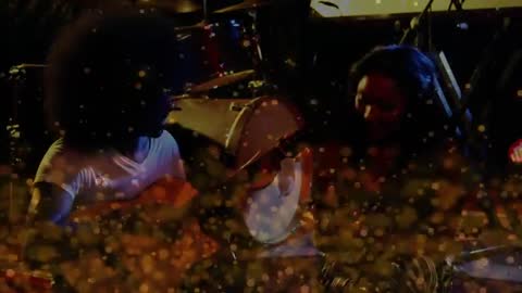 Intimate acoustic duet performing under warm golden bokeh lights on small stage