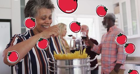 Senior Friends Enjoying Cooking Together with Digital Tomato Icons